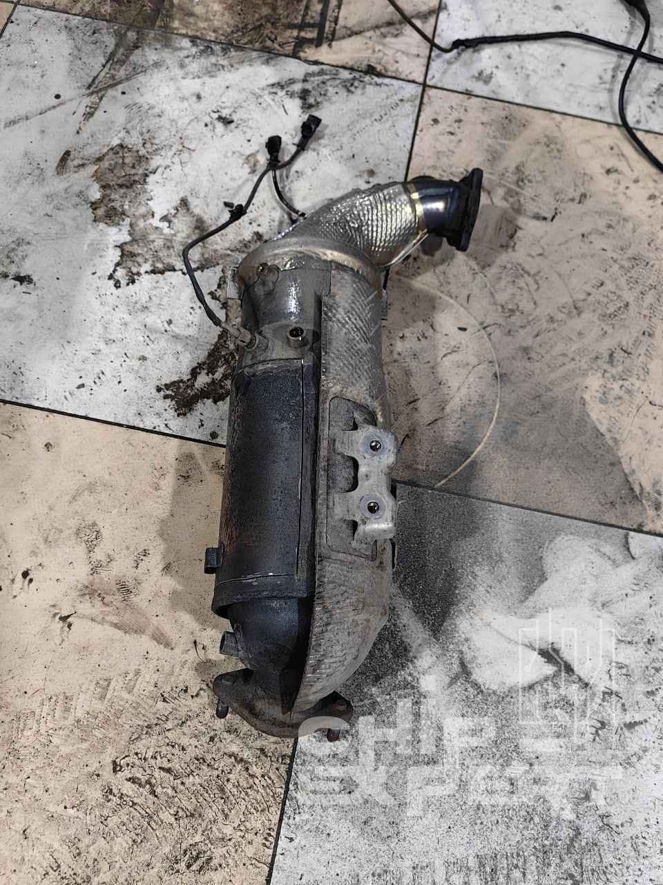 Заваренный блок сажевого фильтра и катализатора лежит на полу Заваренный блок сажевого фильтра и катализатора лежит на полу
